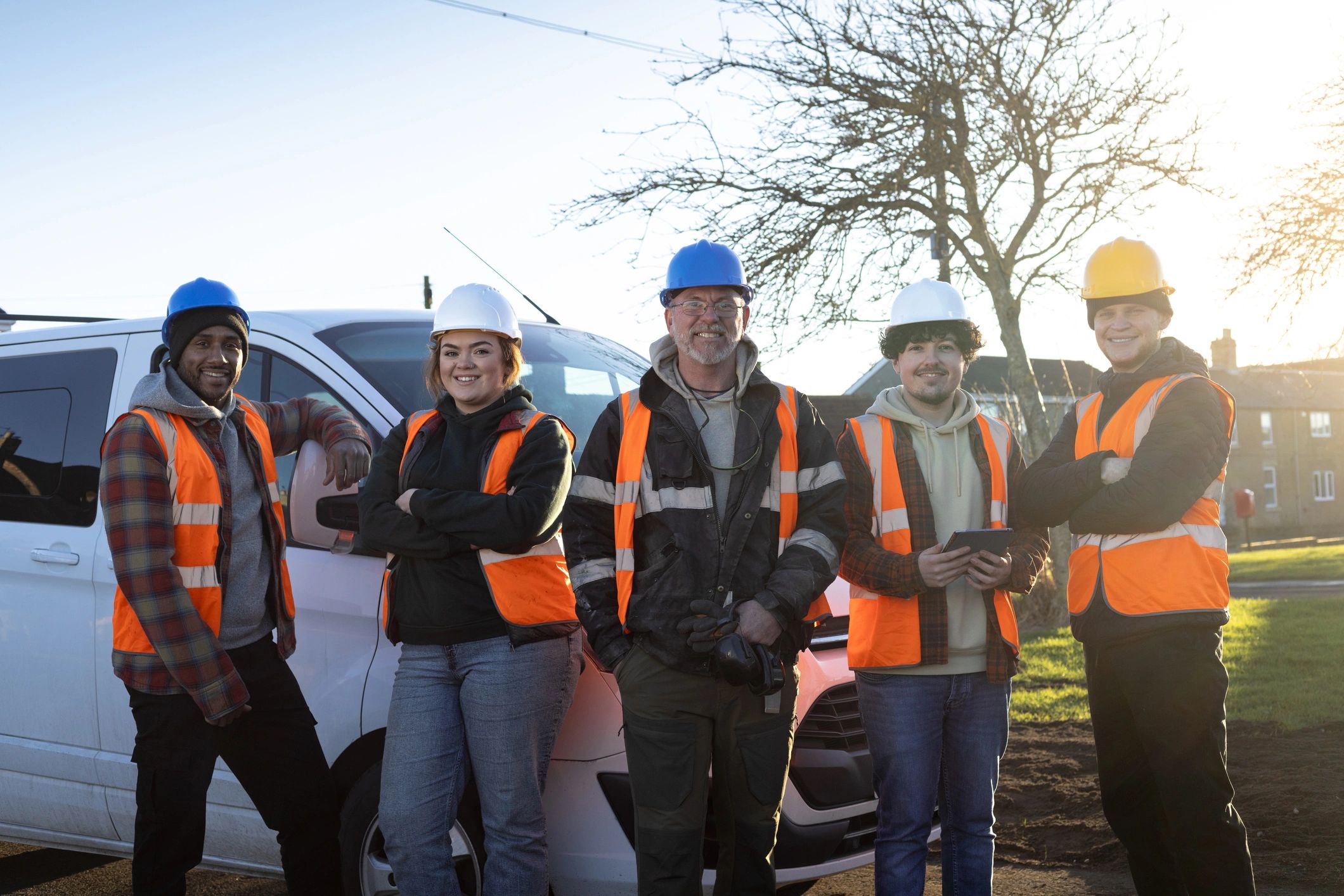 Professional work crew standing together on site